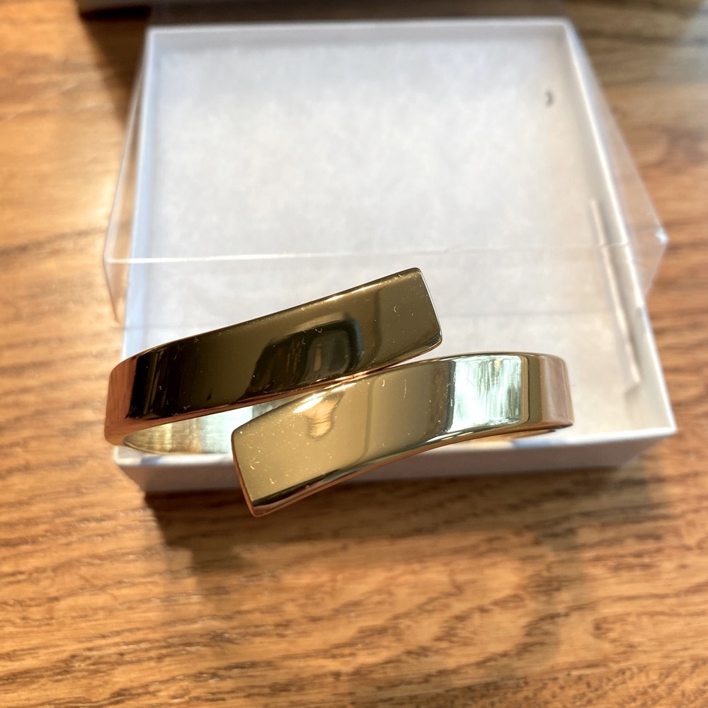 Hinged, gold tone bangle. NWOT